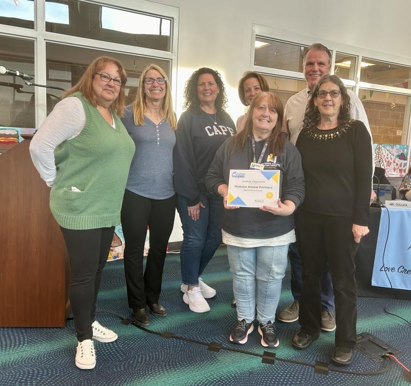 Humane Animal Partners was recognized as a Cape Community Champion at the April 25 school board meeting. Gathered in back are (l-r) Sussex Consortium Job Coach Karen Phillips, Principal Vivian Bush, Sussex Consortium Vocational Coordinator Pam Graves, board President Alison Myers and Superintendent Bob Fulton. In front are HAP lead adoption counselor Kim Doucette and Sussex Consortium Job Coach Sue Murphy. ELLEN DRISCOLL PHOTO